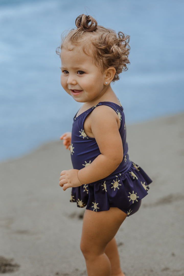 Traje de baño azul marino con soles amarillos para  Bebé Niña