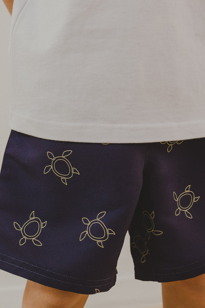 Traje de baño azul marino con tortugas amarillas para Niño