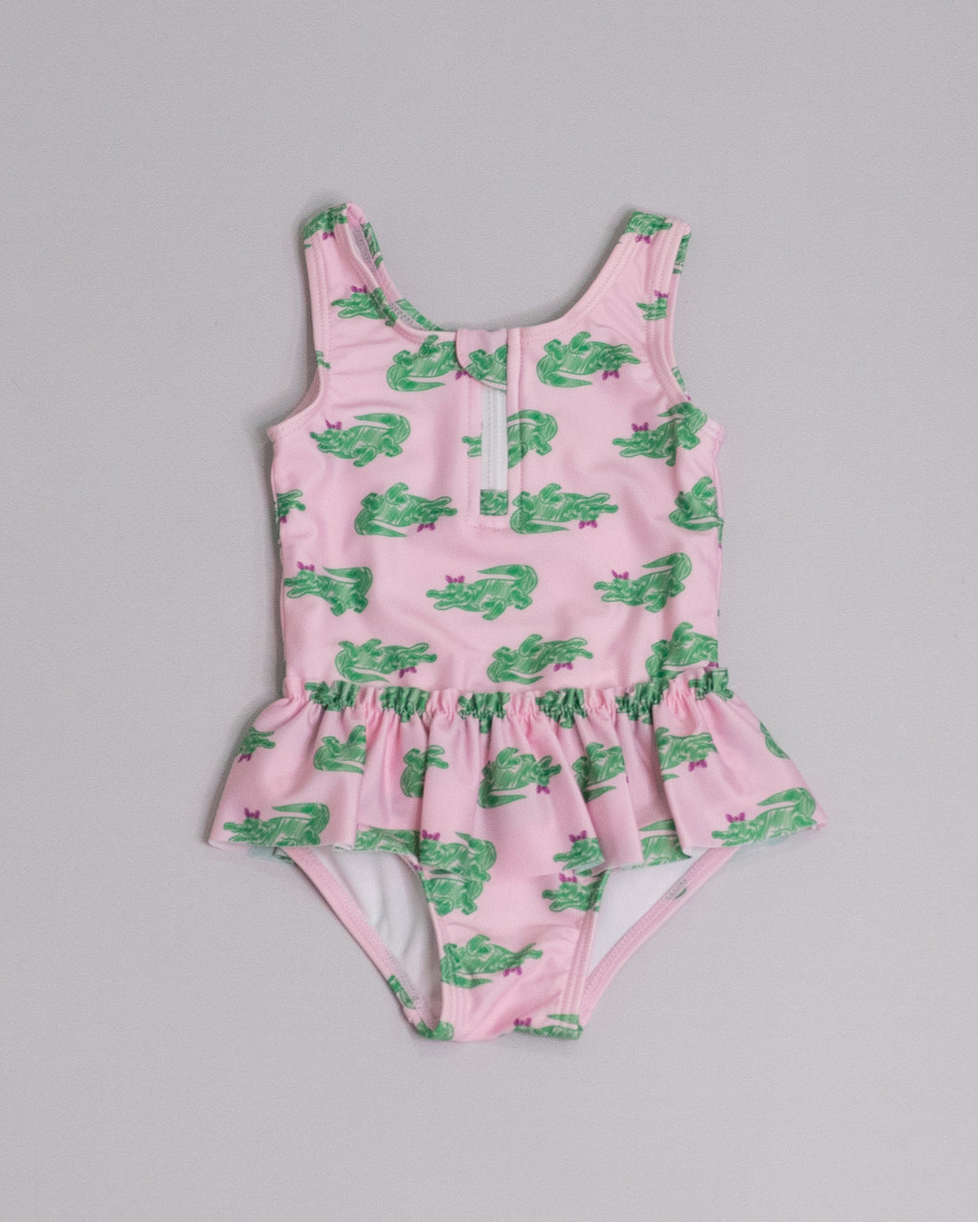 Traje de baño rosado con estampado de cocodrilos verdes