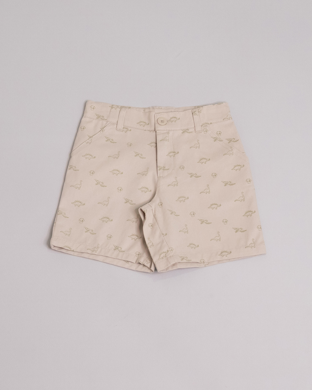 Short beige claro con estampado de dinosaurios y honguitos